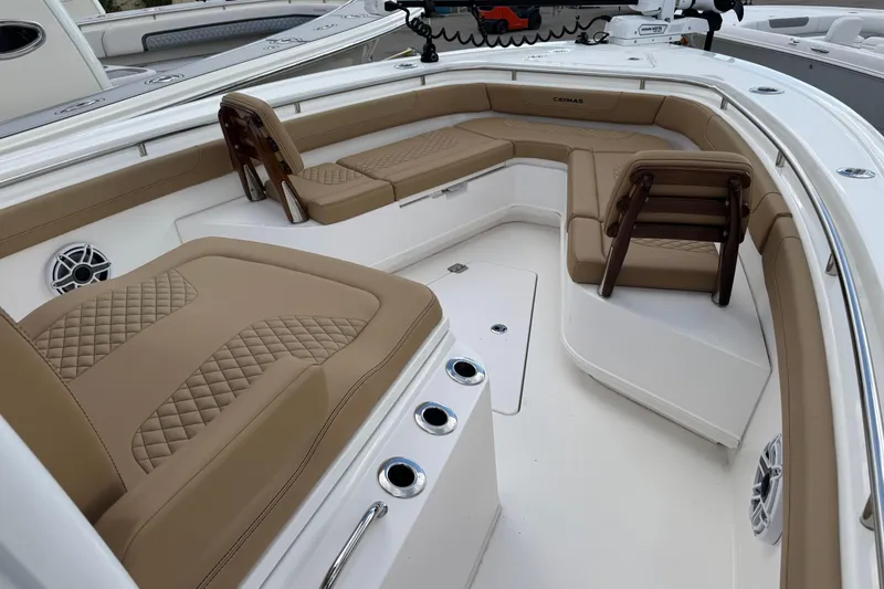 Slide: The Image of 2025 Caymas 291 boat interior with tan cushioned seating and modern design. - 7