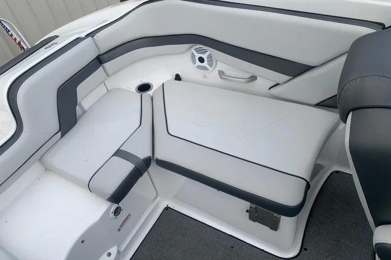 Slide: The Image of 2019 Yamaha Boats AR240 interior seating with gray and white upholstery. - 12