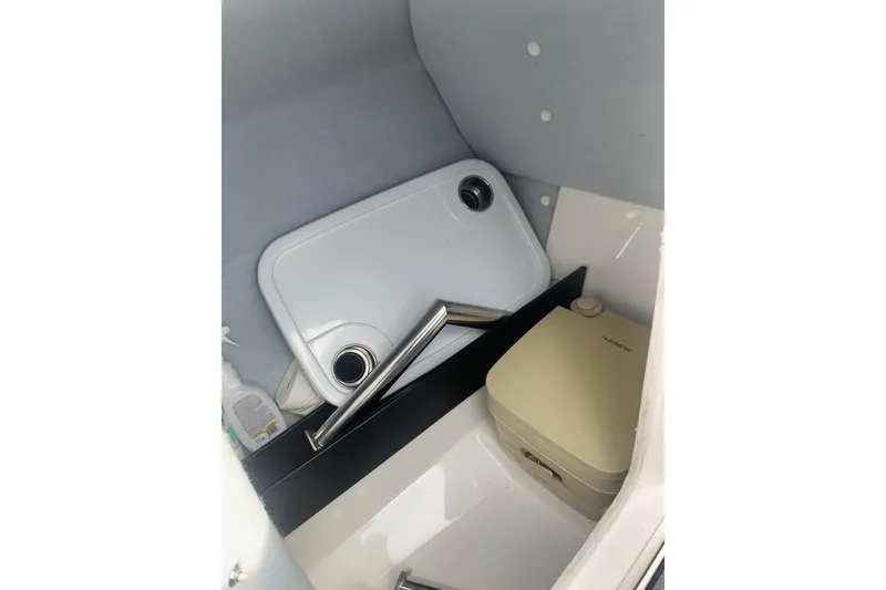 Slide: The Image of 2019 Yamaha AR240 boat interior storage with portable toilet and accessories. - 16