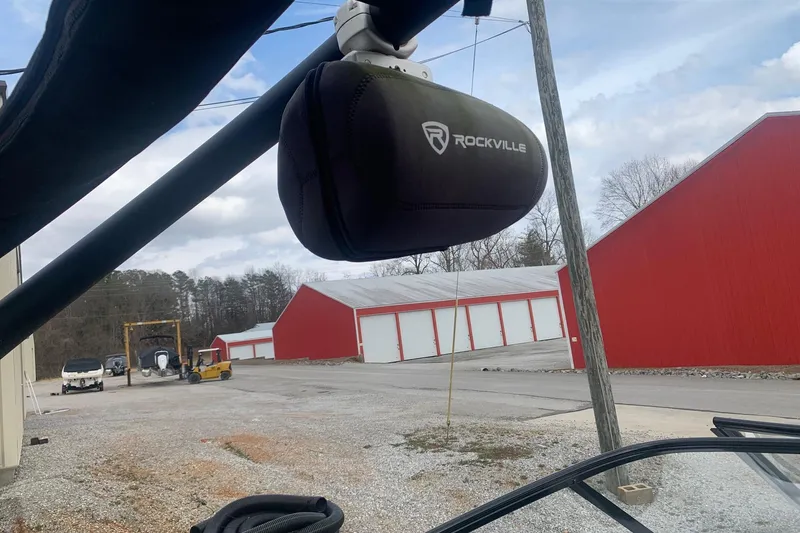 Slide: The Image of 2019 Yamaha AR240 boat with Rockville speaker, red storage buildings in background. - 20