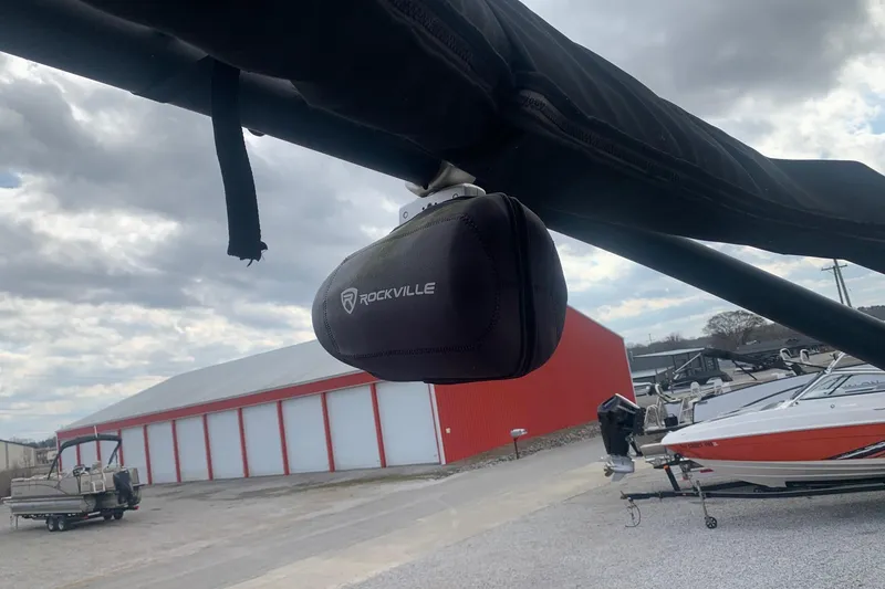 Slide: The Image of 2019 Yamaha AR240 boat with Rockville speaker, docked near red and white building. - 21