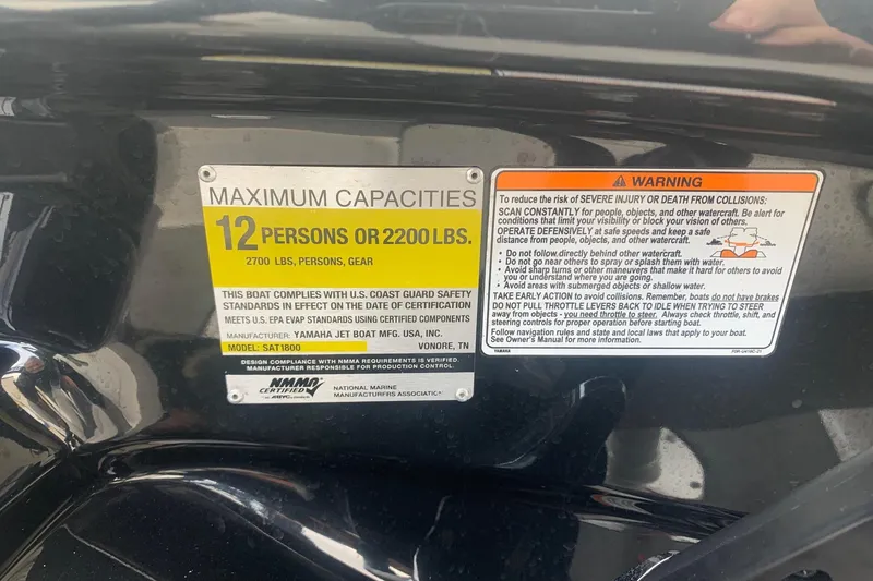 Slide: The Image of 2019 Yamaha Boats AR240 capacity label, 12 persons or 2200 lbs, safety warnings included. - 23
