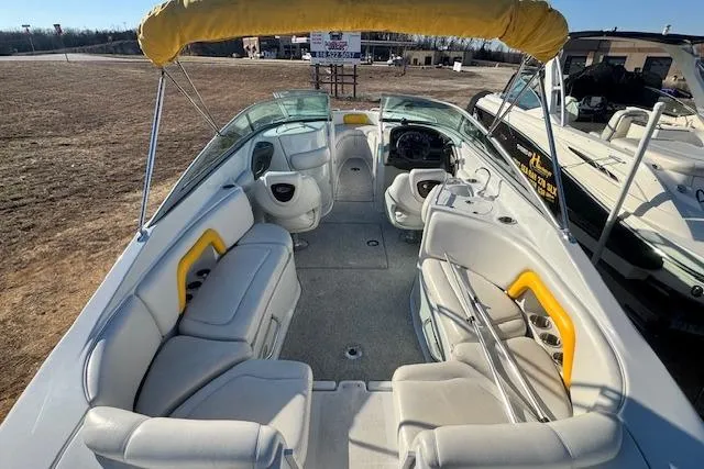 Slide: The Image of 2006 Crownline 270 BR boat interior with yellow accents and spacious seating. - 10