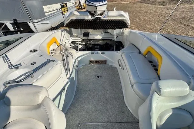 Slide: The Image of 2006 Crownline 270 BR boat interior with seating and open engine compartment. - 12