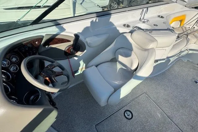 Slide: The Image of 2006 Crownline 270 BR boat cockpit with steering wheel and comfortable seating. - 15
