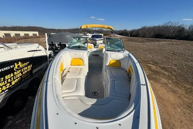 Slide: The Image of 2006 Crownline 270 BR boat with yellow and white interior, parked on dry land. - 5