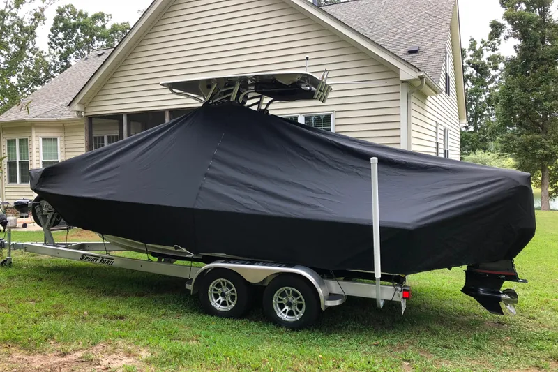 Slide: The Image of 2018 Key West 230 Bay Reef boat covered on trailer beside house. - 10