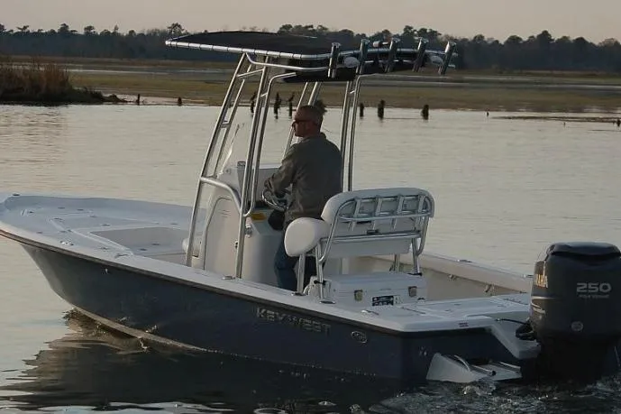 Slide: The Image of 2018 Key West 230 Bay Reef boat with Yamaha engine in a showroom. - 2