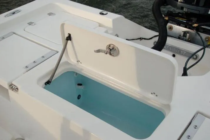 Slide: The Image of 2018 Key West 230 Bay Reef boat interior with storage compartments and seating. - 4