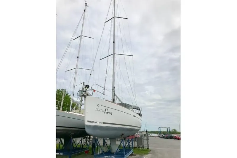 The Image of 2012 Beneteau Oceanis 37 sailboat on stands, overcast sky background. - 0