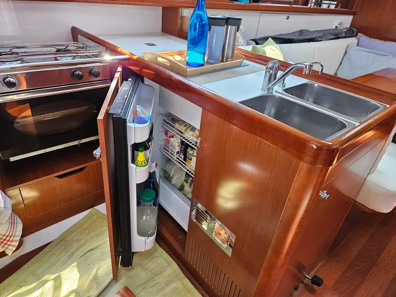 Slide: The Image of Interior of 2012 Beneteau Oceanis 37 yacht kitchen with open fridge and stove. - 18