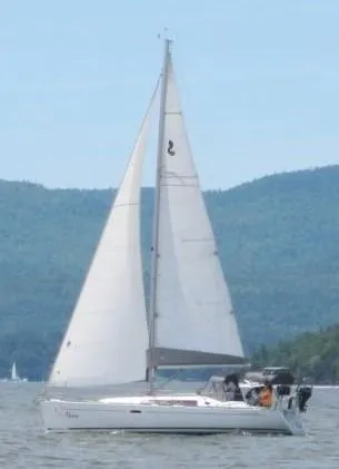 Slide: The Image of 2012 Beneteau Oceanis 37 sailboat on a lake with mountainous backdrop. - 2