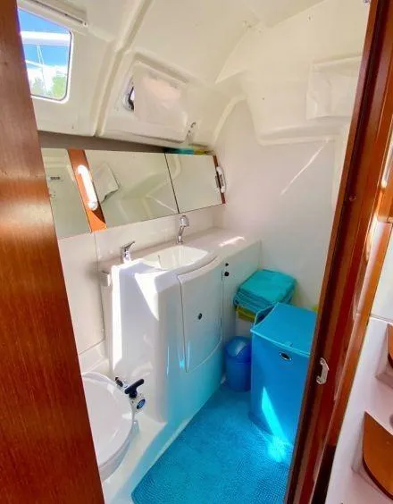 Slide: The Image of Interior of 2012 Beneteau Oceanis 37 yacht bathroom with sink, mirror, and storage. - 31