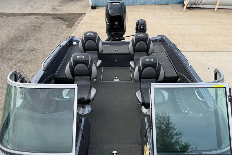 Slide: The Image of 2015 Lund 202 Pro-V GL boat interior with seating and windshield. - 14