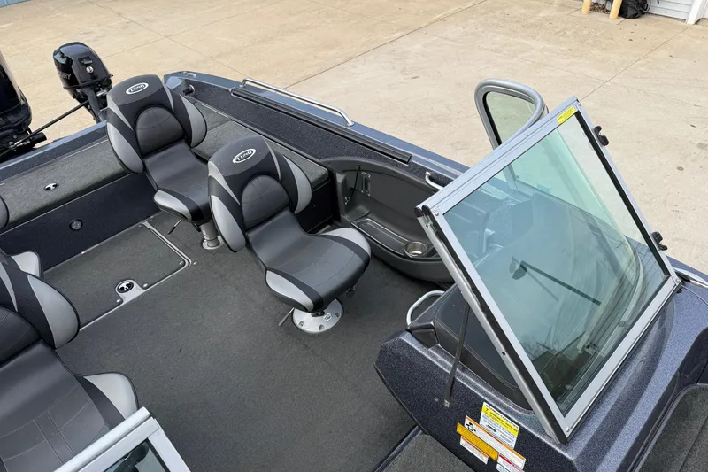 Slide: The Image of 2015 Lund 202 Pro-V GL boat interior with seating and windshield. - 16
