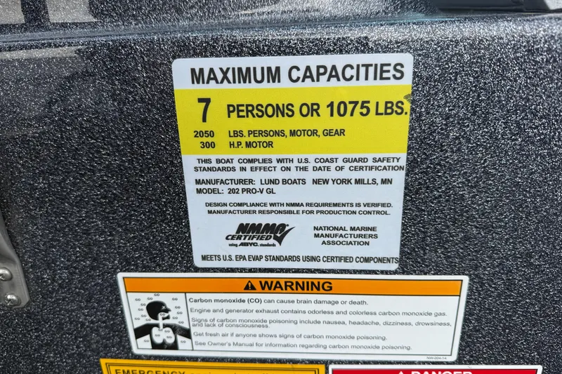 Slide: The Image of 2015 Lund 202 Pro-V GL capacity label, 7 persons or 1075 lbs, safety warnings included. - 19
