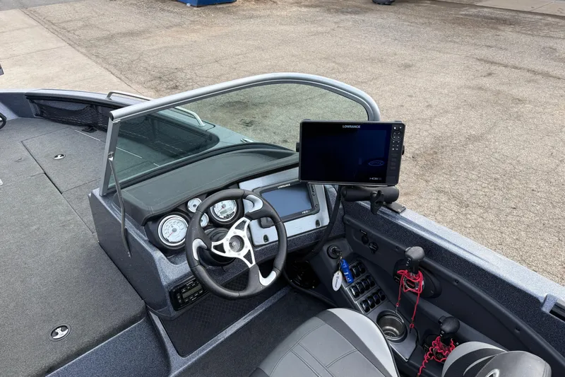 Slide: The Image of 2015 Lund 202 Pro-V GL boat dashboard with steering wheel and navigation system. - 20