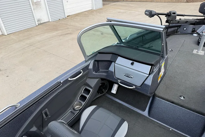 Slide: The Image of 2015 Lund 202 Pro-V GL boat interior with seating and storage compartments. - 24