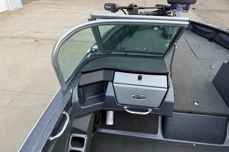 Slide: The Image of 2015 Lund 202 Pro-V GL boat interior with windshield and storage compartment. - 25