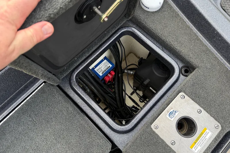 Slide: The Image of 2015 Lund 202 Pro-V GL boat compartment with wiring and components visible. - 31