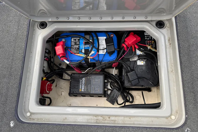 Slide: The Image of 2015 Lund 202 Pro-V GL boat battery compartment with wiring and charger. - 33