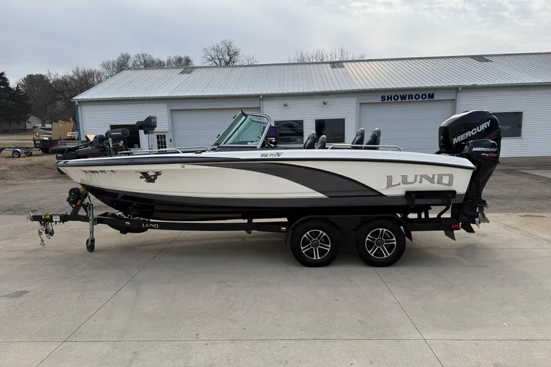 Slide: The Image of 2015 Lund 202 Pro-V GL boat on trailer outside showroom. - 5
