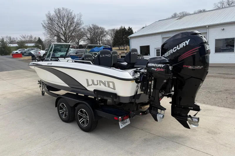Slide: The Image of 2015 Lund 202 Pro-V GL boat with dual Mercury engines on a trailer. - 6
