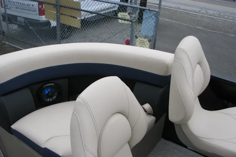 Slide: The Image of 2026 Berkshire 24 E CTS boat interior with beige seating and built-in speaker. - 11