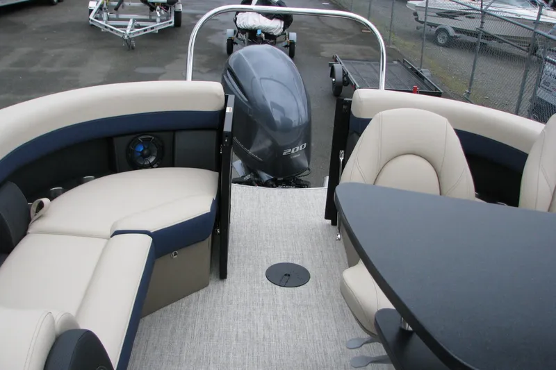 Slide: The Image of 2026 Berkshire 24 E CTS pontoon boat interior with seating and outboard motor. - 16