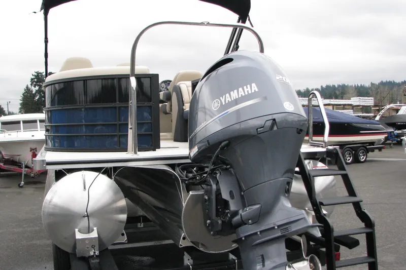Slide: The Image of 2026 Berkshire 24 E CTS pontoon boat with Yamaha outboard motor, docked outdoors. - 17