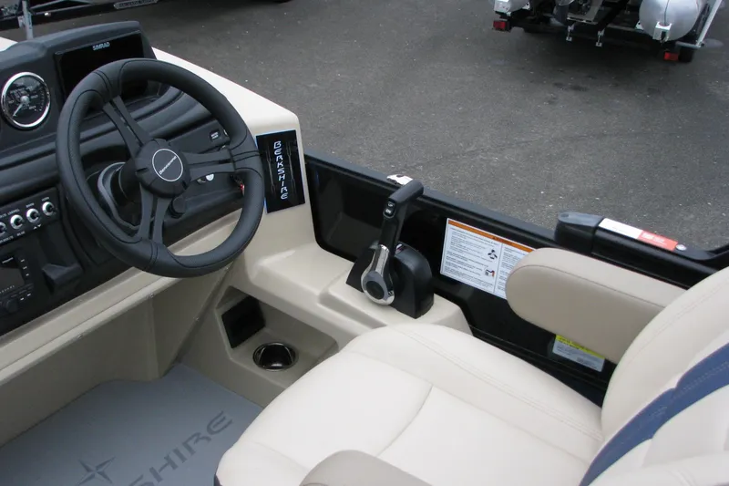 Slide: The Image of Interior of 2026 Berkshire 24 E CTS boat with steering wheel and controls. - 5