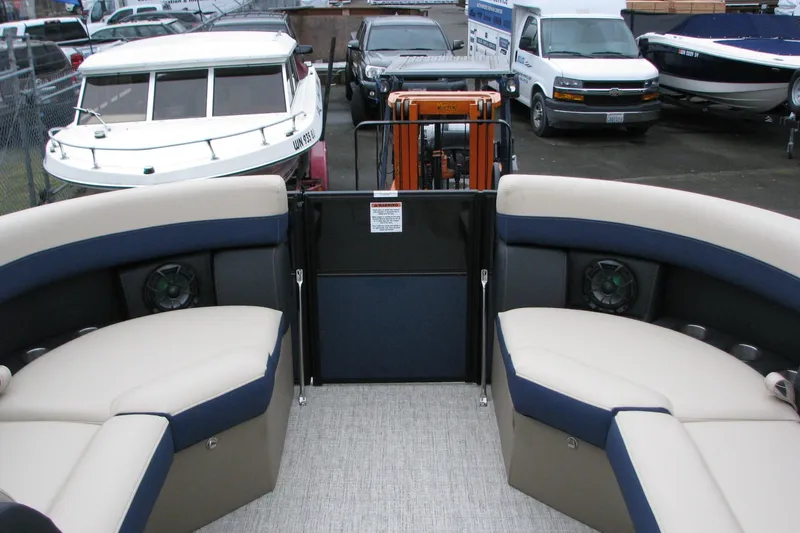 Slide: The Image of 2026 Berkshire 24 E CTS pontoon boat interior with beige and blue seating. - 7