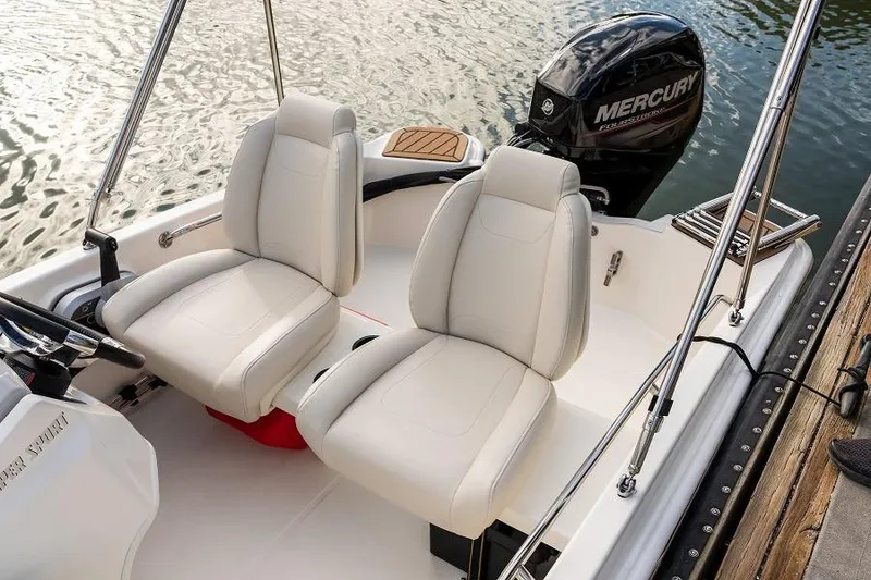 Slide: The Image of Manufacturer Provided Image: 2025 Boston Whaler 130 Super Sport boat interior with two white seats and Mercury engine. - 12