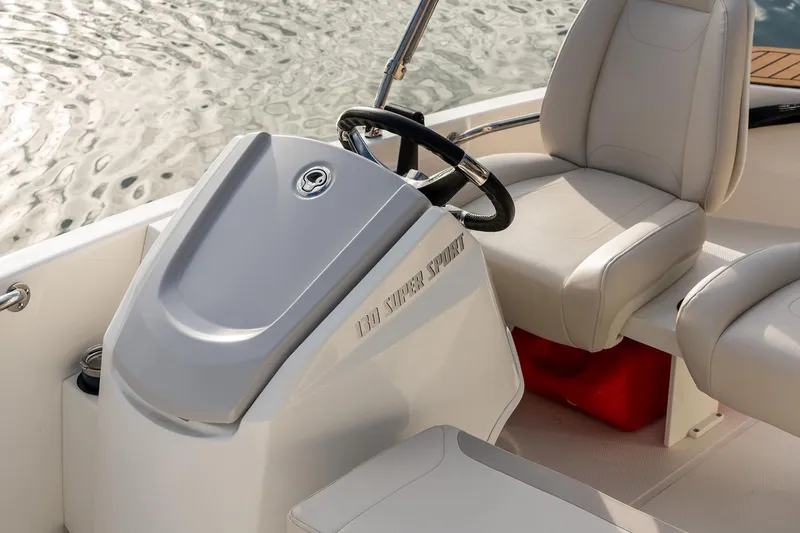 Slide: The Image of Manufacturer Provided Image: 2025 Boston Whaler 130 Super Sport boat interior with steering wheel and seating. - 9