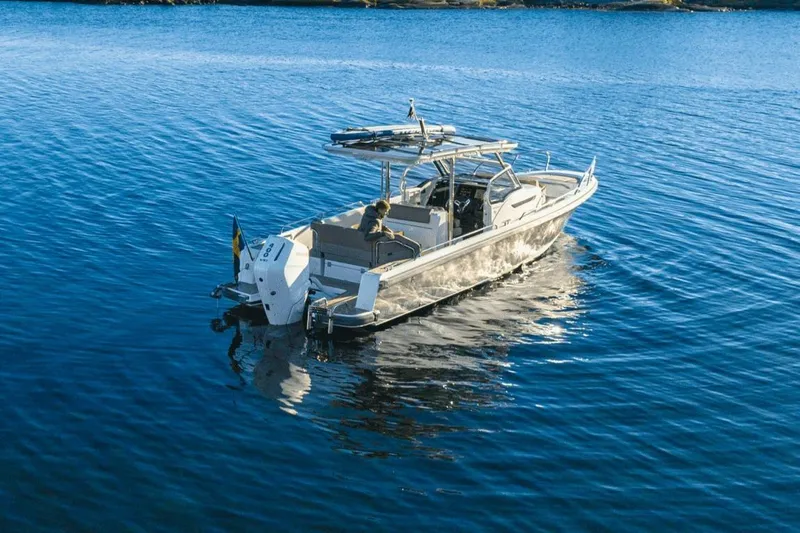 Slide: The Image of Nimbus T9 2025 motorboat cruising on calm blue waters. - 2