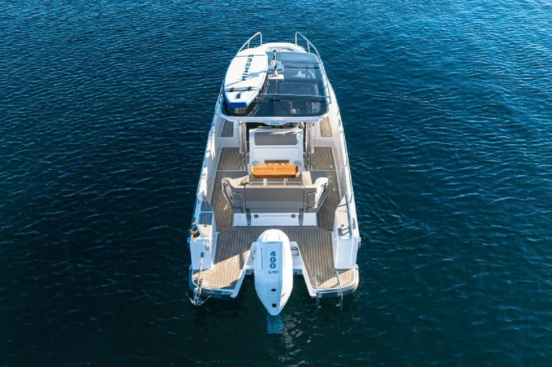 Slide: The Image of Nimbus T9 2025 motorboat on clear blue water, aerial view. - 3