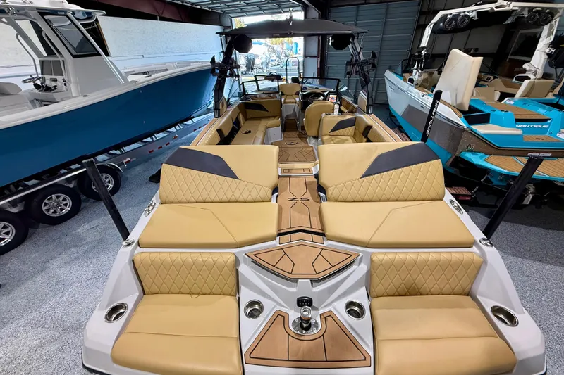 Slide: The Image of 2023 Tigé Z5 boat with luxurious tan seating and sleek design in showroom. - 10