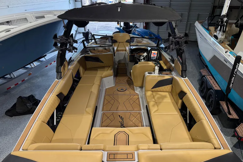 Slide: The Image of 2023 Tigé Z5 boat interior with tan leather seating and modern dashboard. - 11