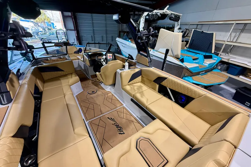 Slide: The Image of 2023 Tigé Z5 boat interior with tan leather seating and modern dashboard. - 13