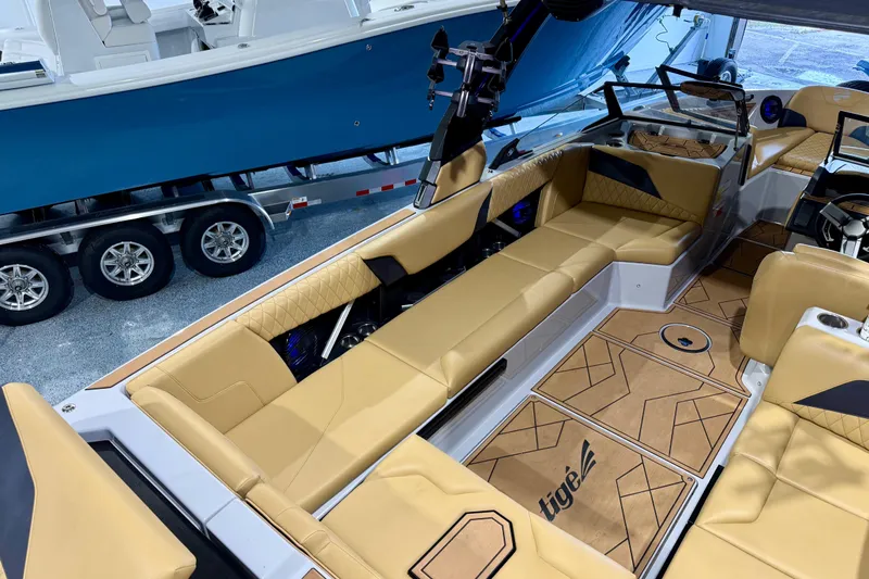 Slide: The Image of 2023 Tigé Z5 boat interior with tan seating and stylish flooring design. - 14