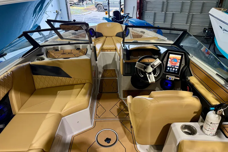 Slide: The Image of 2023 Tigé Z5 boat interior with tan leather seats and modern dashboard controls. - 15