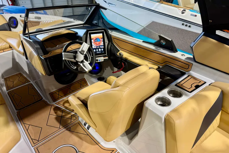 Slide: The Image of 2023 Tigé Z5 boat interior with modern dashboard and tan seating. - 17