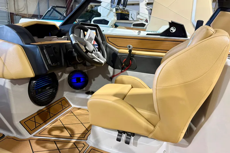 Slide: The Image of 2023 Tigé Z5 boat interior with tan leather seats and modern dashboard. - 19