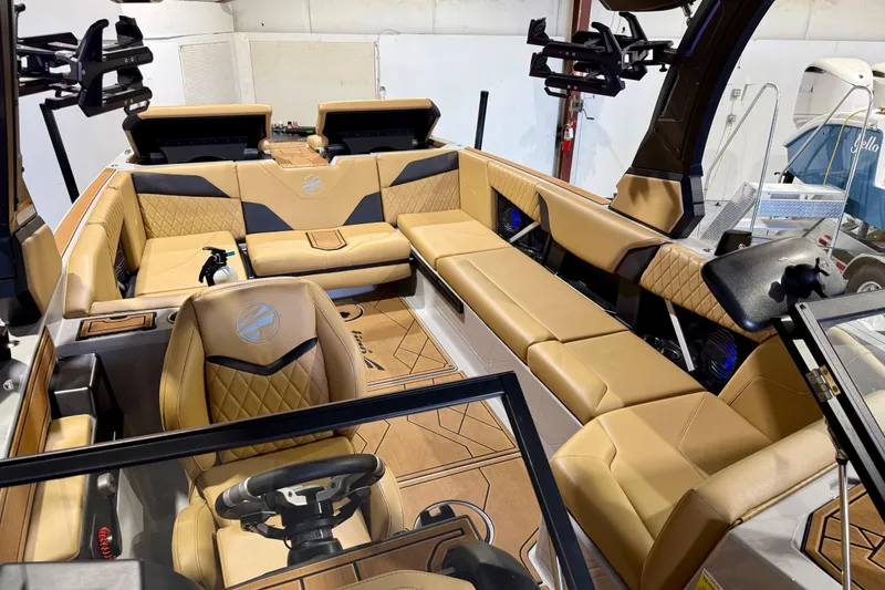 Slide: The Image of 2023 Tigé Z5 boat interior with luxurious tan seating and modern dashboard. - 22