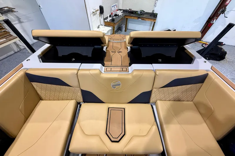Slide: The Image of 2023 Tigé Z5 boat interior with tan and black seating, featuring diamond stitching and modern design. - 24