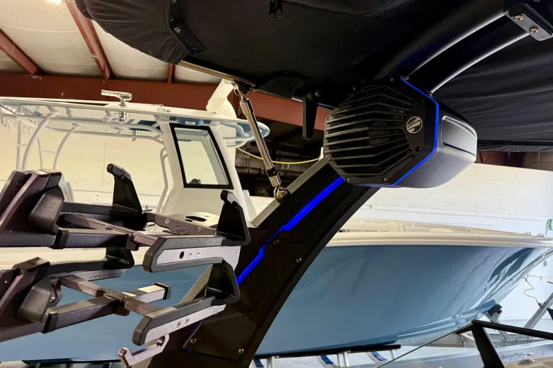 Slide: The Image of 2023 Tigé Z5 boat with wakeboard rack and speaker system in showroom. - 26