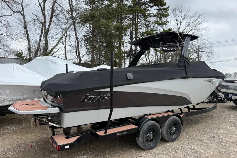 Slide: The Image of 2023 Tigé Z5 boat in showroom, featuring tan seating and sleek design. - 3