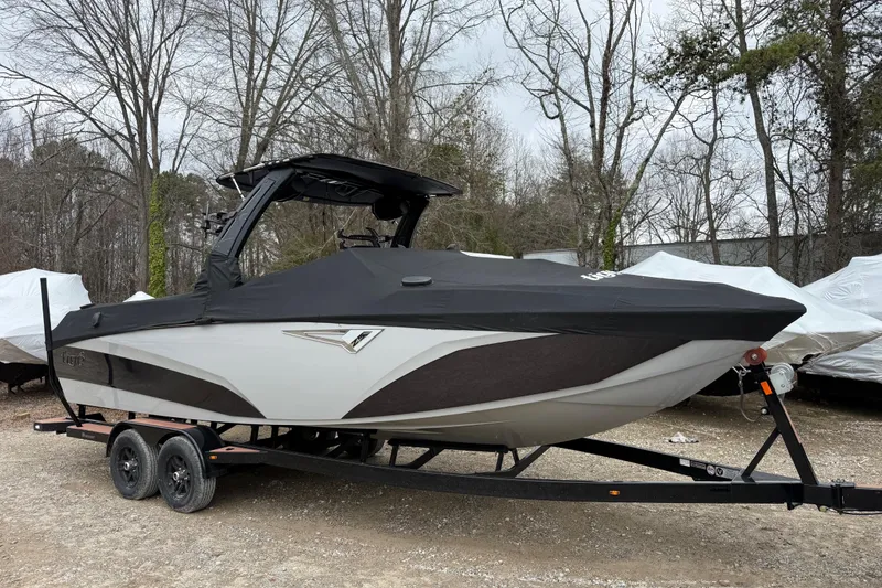 Slide: The Image of 2023 Tigé Z5 boat with tan seating and stylish deck design in a showroom. - 4