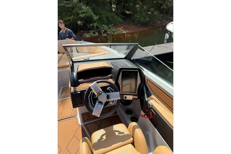 Slide: The Image of 2023 Tigé Z5 boat rear view showcasing propeller and trailer in showroom. - 5