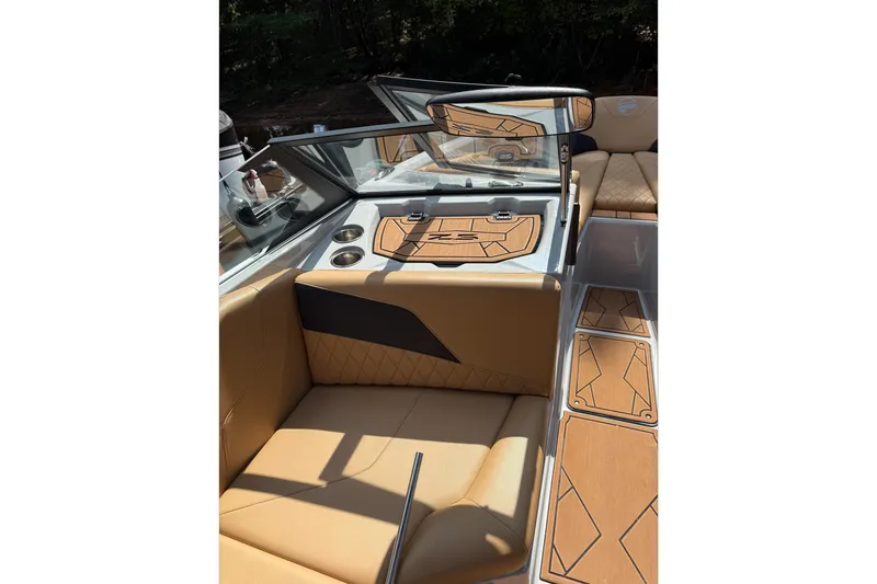 Slide: The Image of 2023 Tigé Z5 boat in a warehouse, featuring sleek design and tan seating. - 6